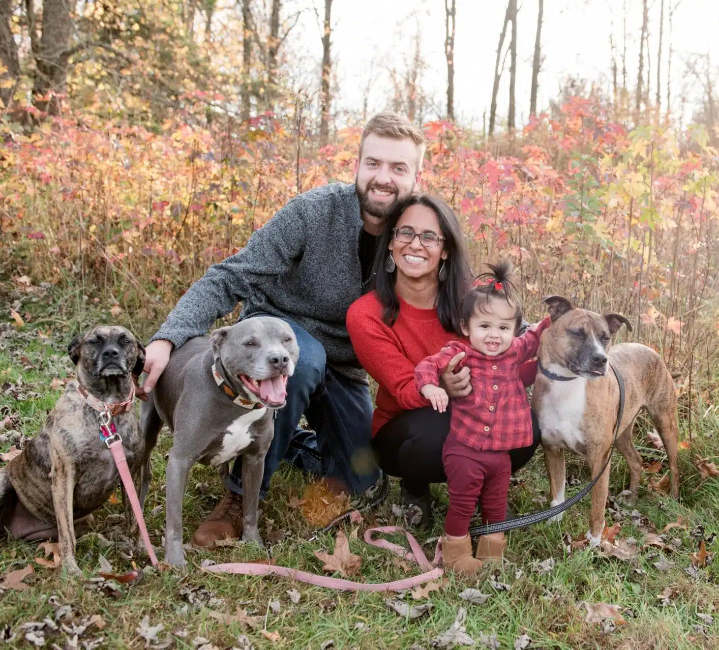 Business owners holding their 3 dogs